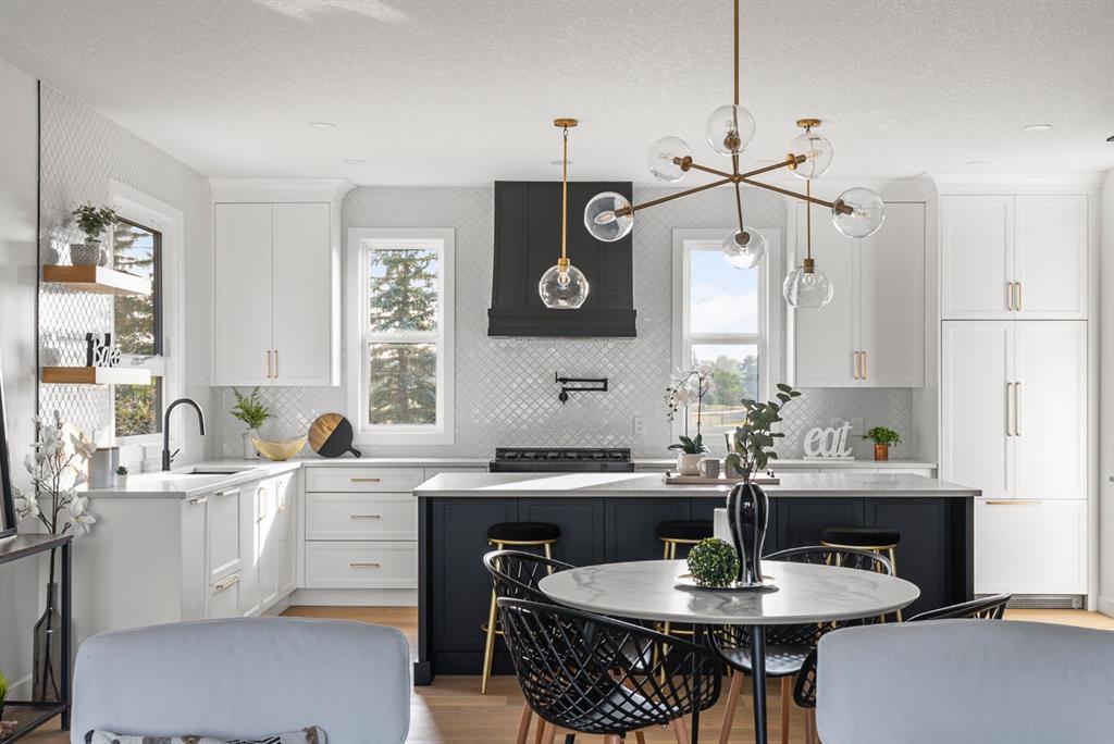 Bright white kitchen with a large island in a completed Calgary renovation